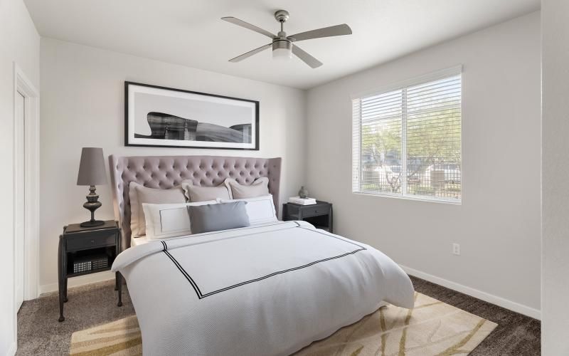 a bedroom with a bed and a fan