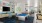 a room with a pool table and chairs