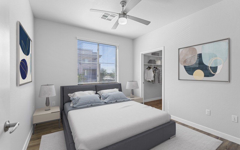 a bedroom with a bed and a fan