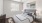 a bedroom with a fan and a bed