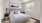 a bedroom with a bed and a fan