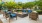 a patio with chairs and a fire pit
